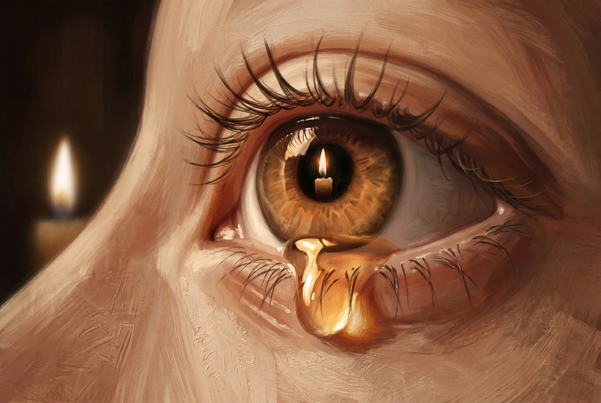 Close-up of an eye with a small candle flame reflected in the pupil and a tear welling on the lower lid
